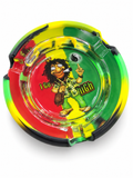 Rasta graphic round glass ashtray with yellow green and black silicone sleeve on white background