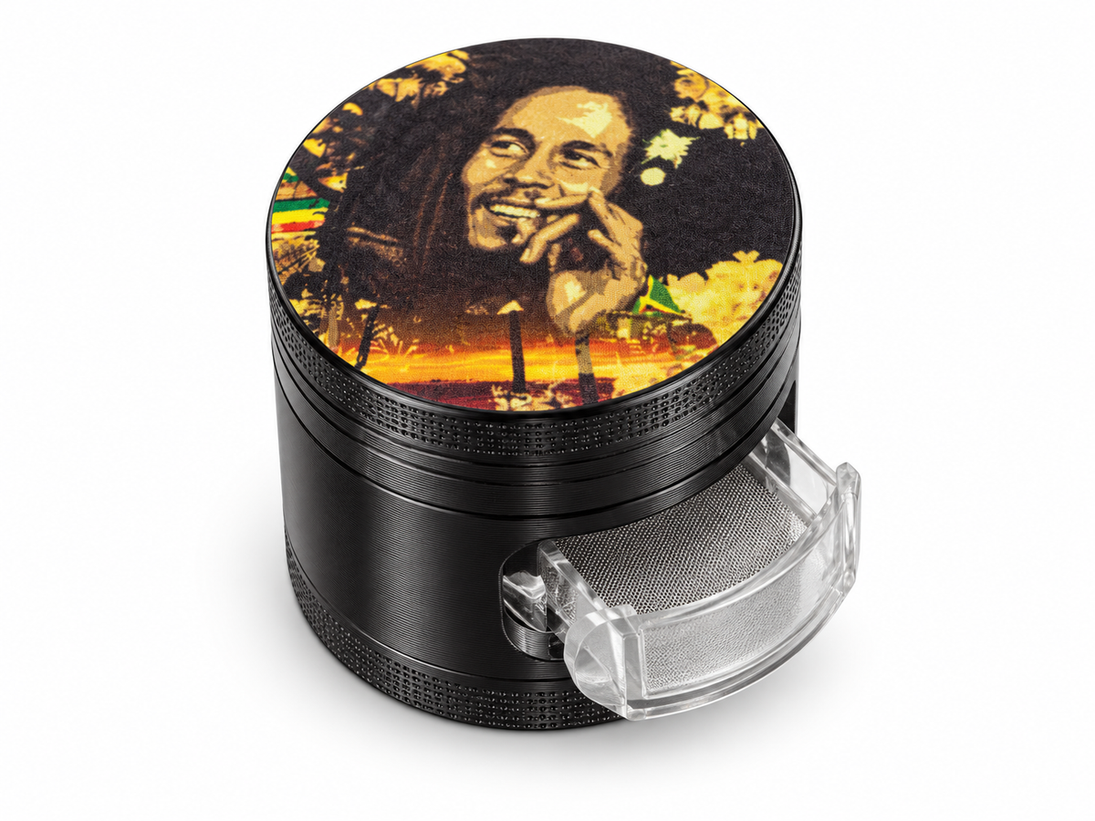 Gold-tone portrait herb grinder with black body and clear slide-out mesh screen on white background